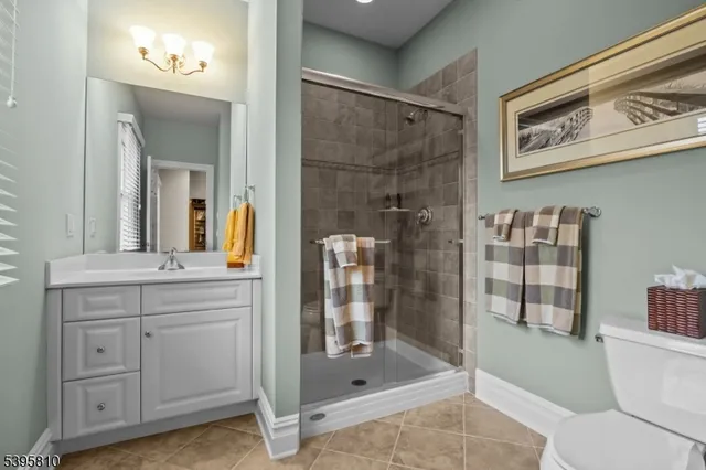 a bathroom with a shower toilet and sink