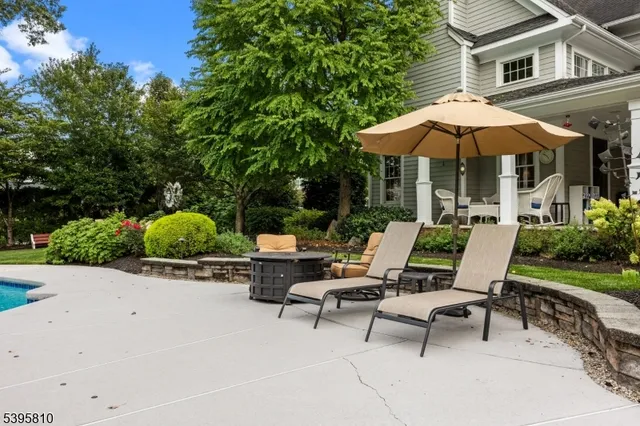 a view of backyard with outdoor seating and trees
