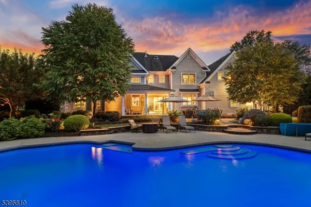 a front view of a house with swimming pool having outdoor seating
