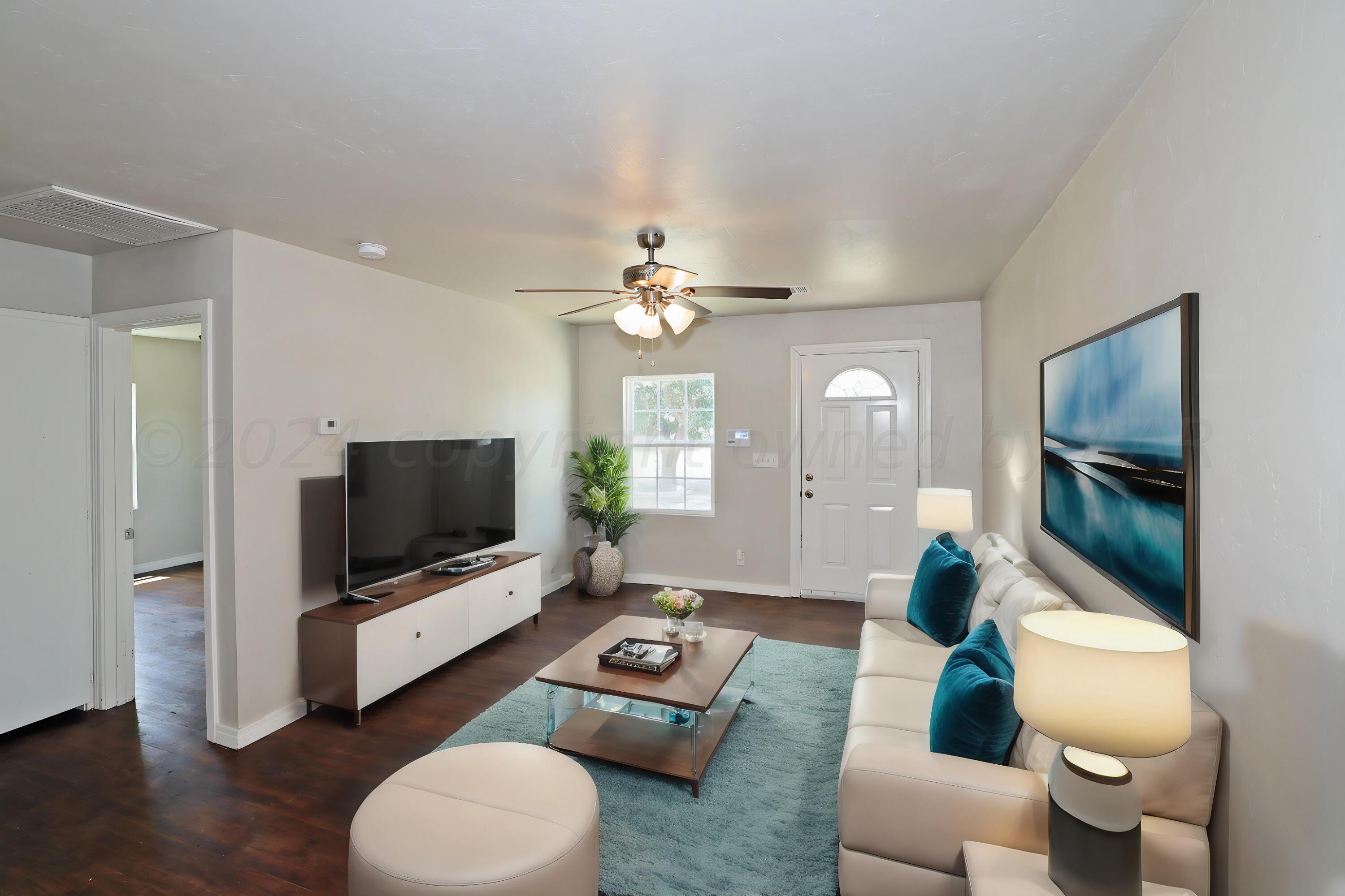 4105 South Hughes Street Amarillo, TX 79110 - Photo 1 of 1 a living room with furniture and a flat screen tv