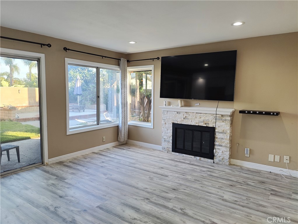 6953 Saddleback Place Rancho Cucamonga, CA 91701 - Photo 10 of 62 Family room with fireplace and patio door to backyard