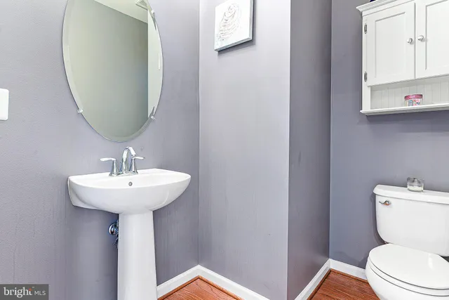 a bathroom with a toilet a sink and a mirror
