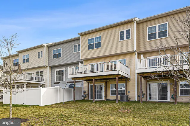 a view of a white building with large windows