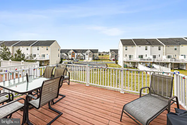 a balcony with furniture and a wooden floor
