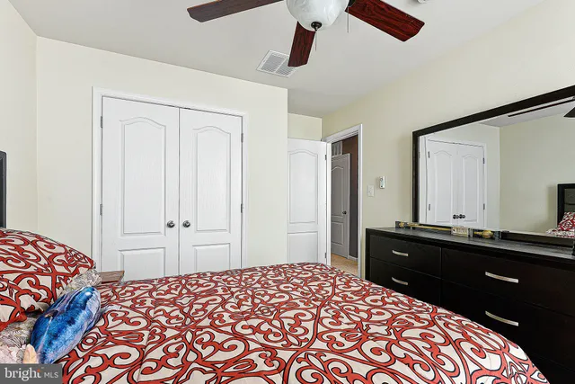 a bedroom with a bed and a dresser