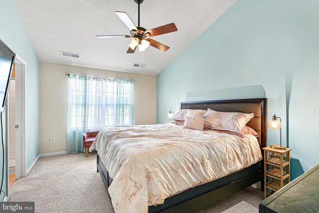 a bed sitting in a bedroom next to a window