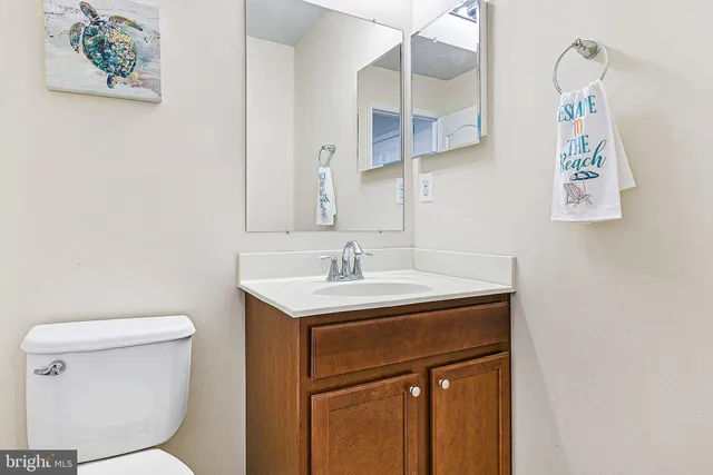 a bathroom with a sink a toilet and a mirror