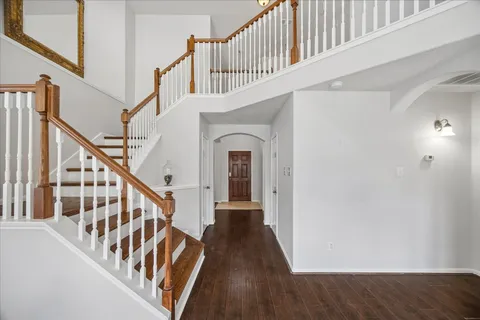 a view of staircase with wooden floor and a metal railing