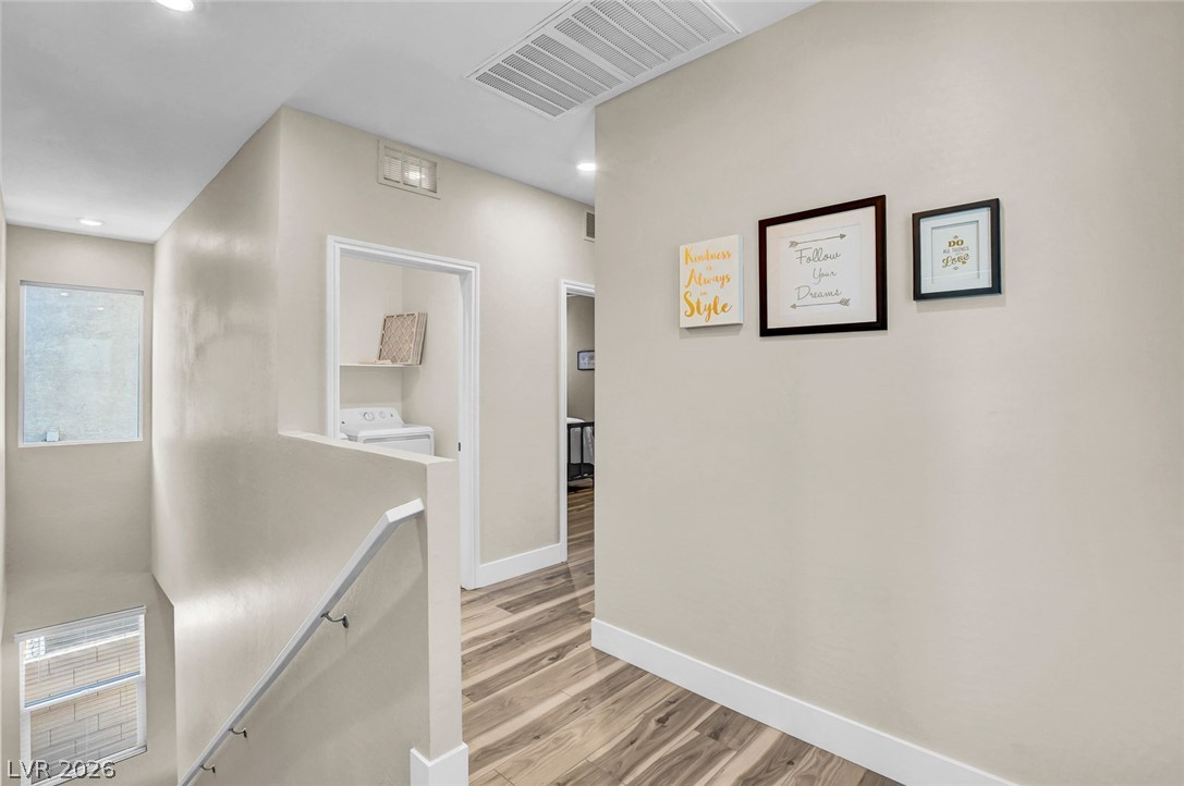 9688 Rankin Rdg Court Las Vegas, NV 89178 - Photo 23 of 53 Hardwood flooring and crisp white trim create a bright, inviting hallway connecting spaces.