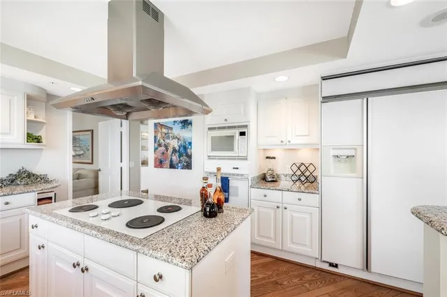 a kitchen with a stove a sink and a refrigerator