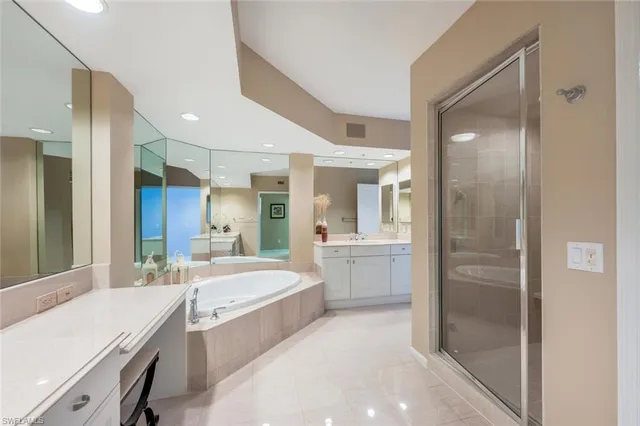 a spacious bathroom with a shower a sink and a mirror
