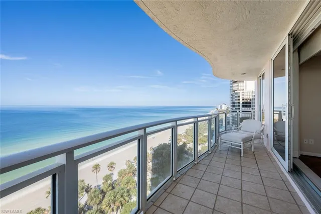 a living room with couches and large view of kitchen
