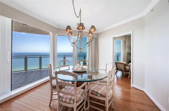 a view of a dining room with furniture wooden floor and chandelier