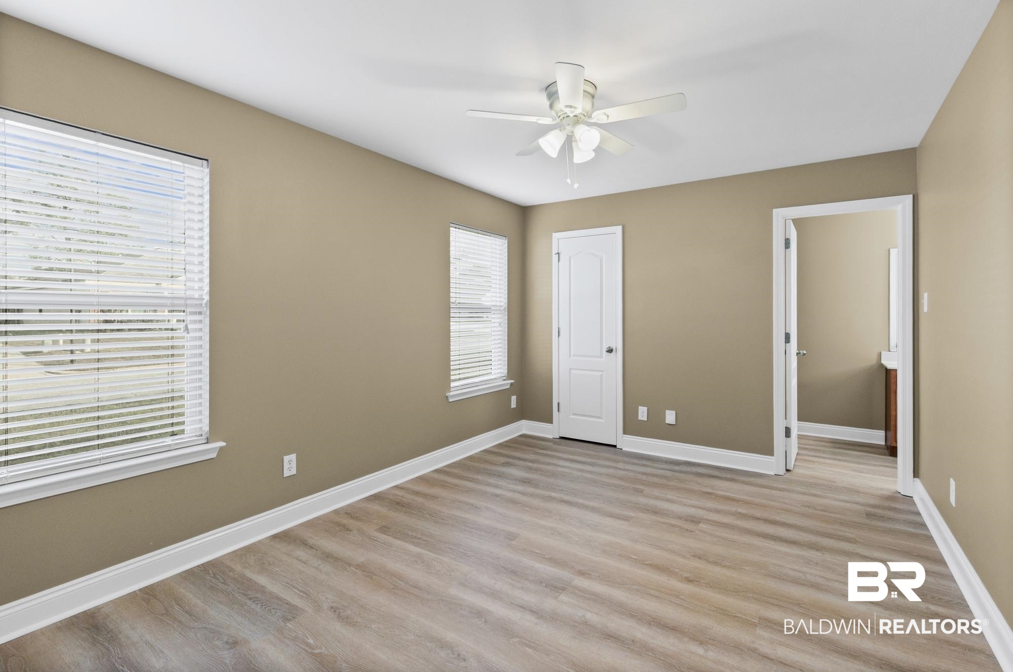 2084 Redpine Drive Semmes, AL 36575 - Photo 13 of 22 Unfurnished bedroom featuring light wood-type flooring, ceiling fan, and a closet
