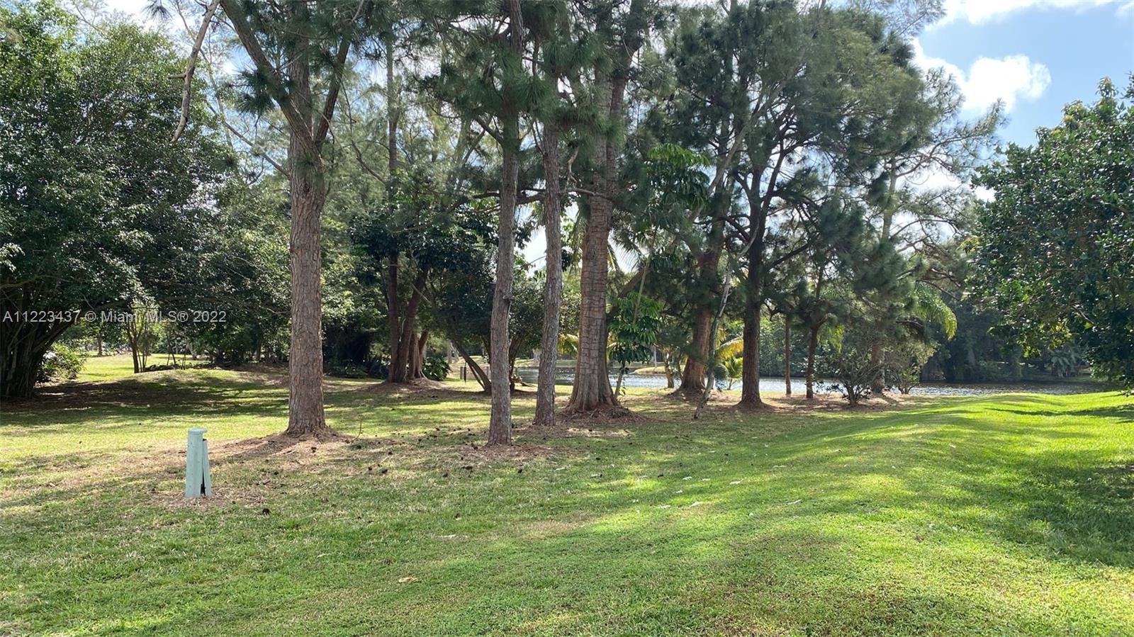 6017 Le Lac Road Boca Raton, FL 33496 - Photo 13 of 46 a view of a park with swings and trees