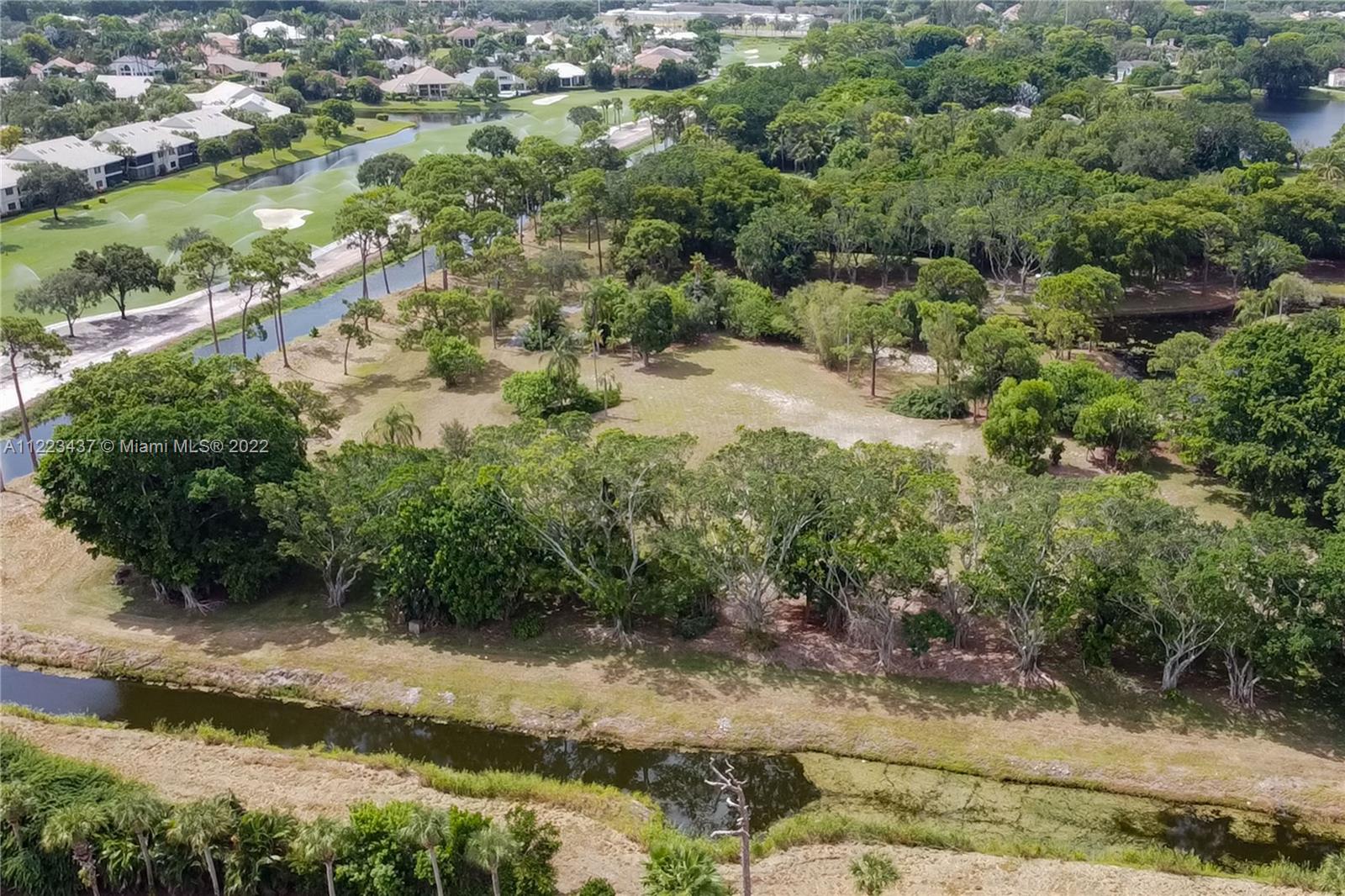 6017 Le Lac Road Boca Raton, FL 33496 - Photo 19 of 46 an aerial view of residential houses with outdoor space and trees