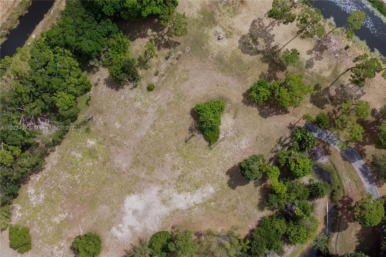 6017 Le Lac Road Boca Raton, FL 33496 - Photo 20 of 46 an aerial view of a house with a yard