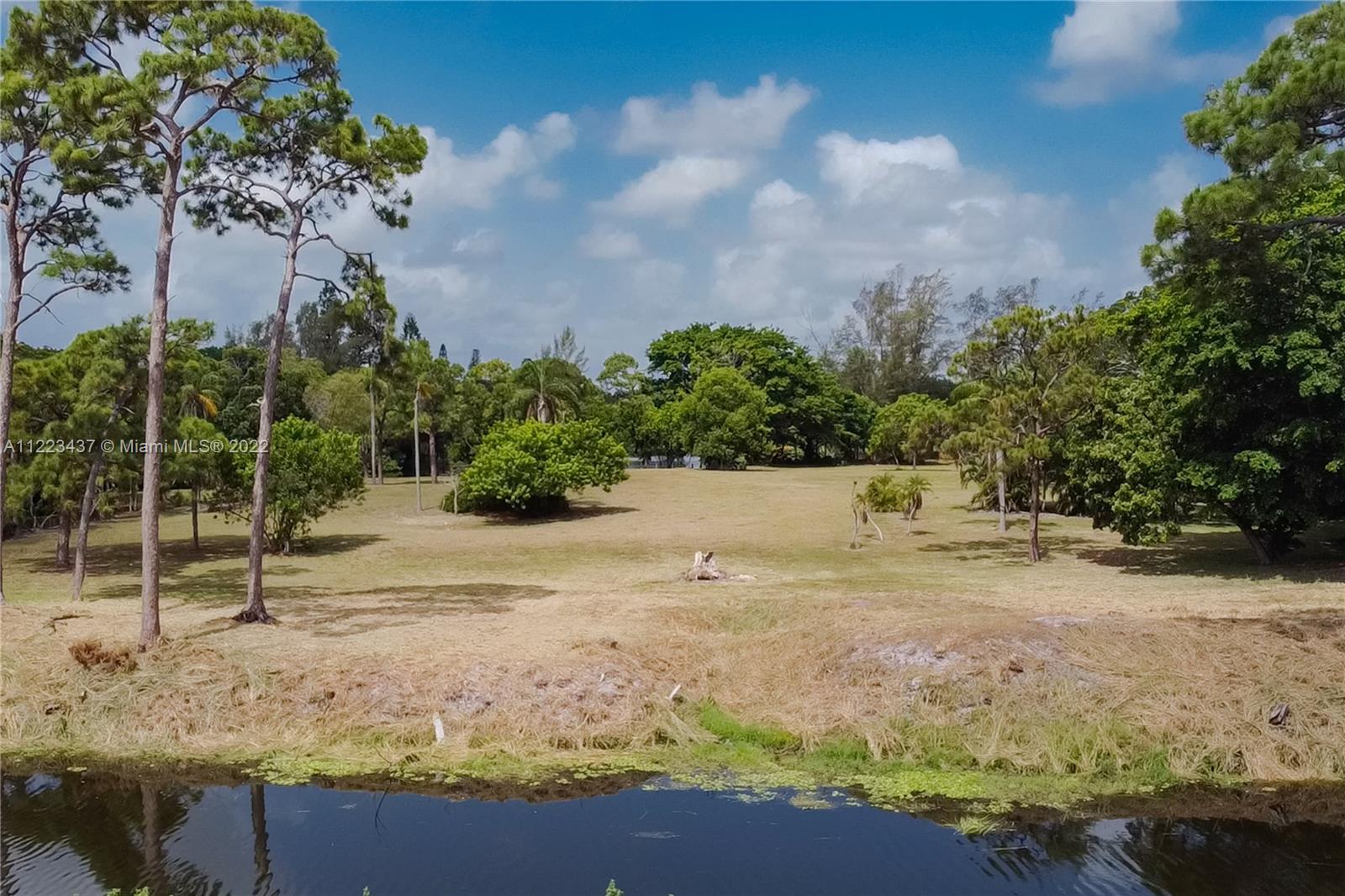 6017 Le Lac Road Boca Raton, FL 33496 - Photo 24 of 46 a view of a yard with wooden fence