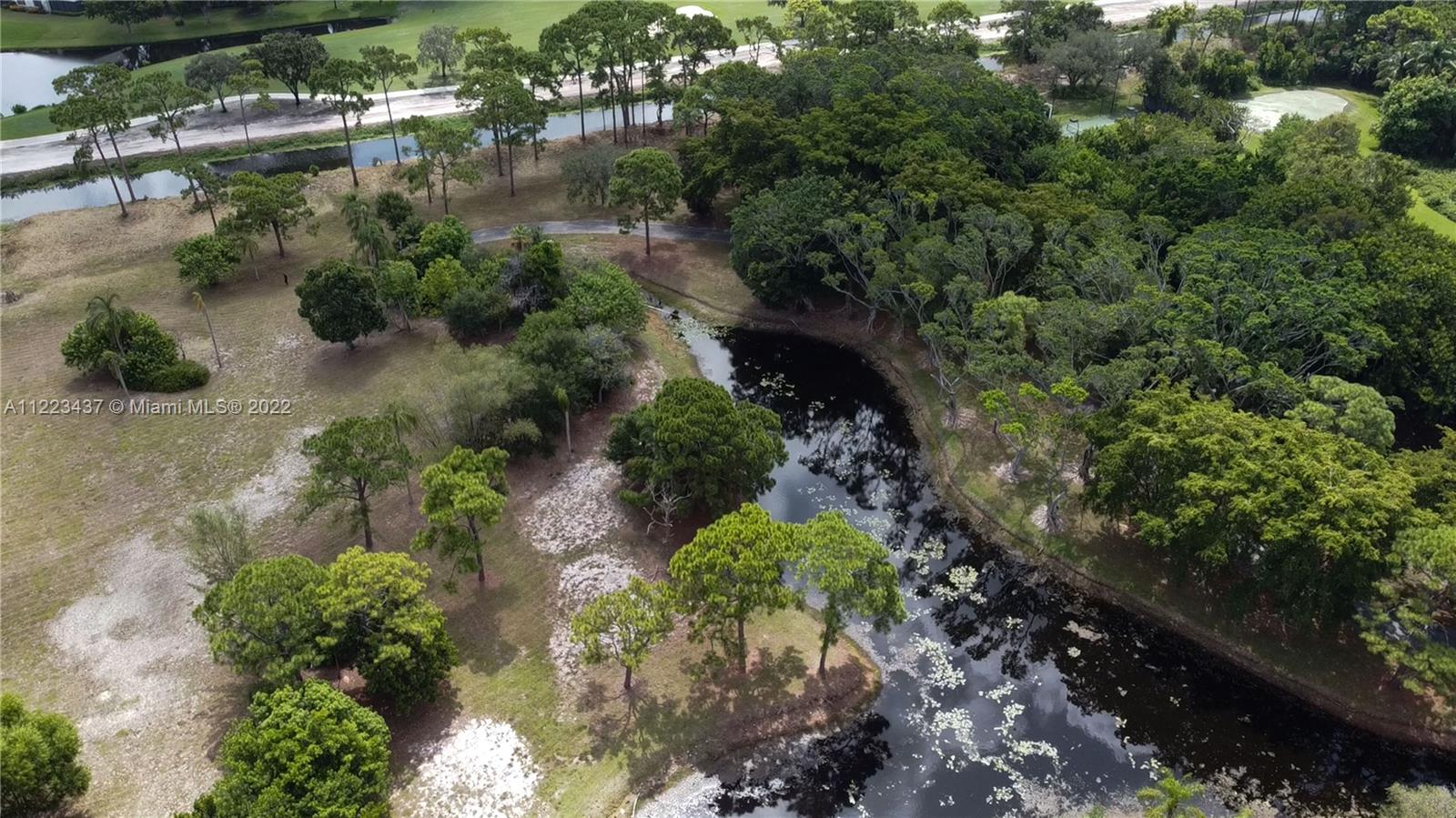 6017 Le Lac Road Boca Raton, FL 33496 - Photo 27 of 46 an aerial view of a house with a yard