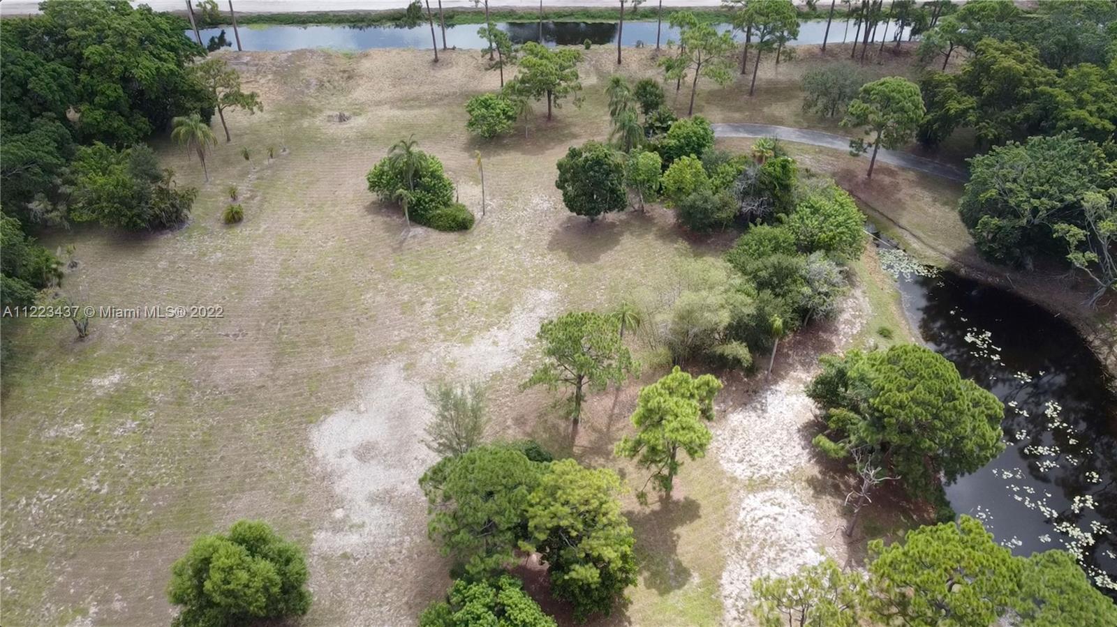6017 Le Lac Road Boca Raton, FL 33496 - Photo 28 of 46 an aerial view of a house with a yard