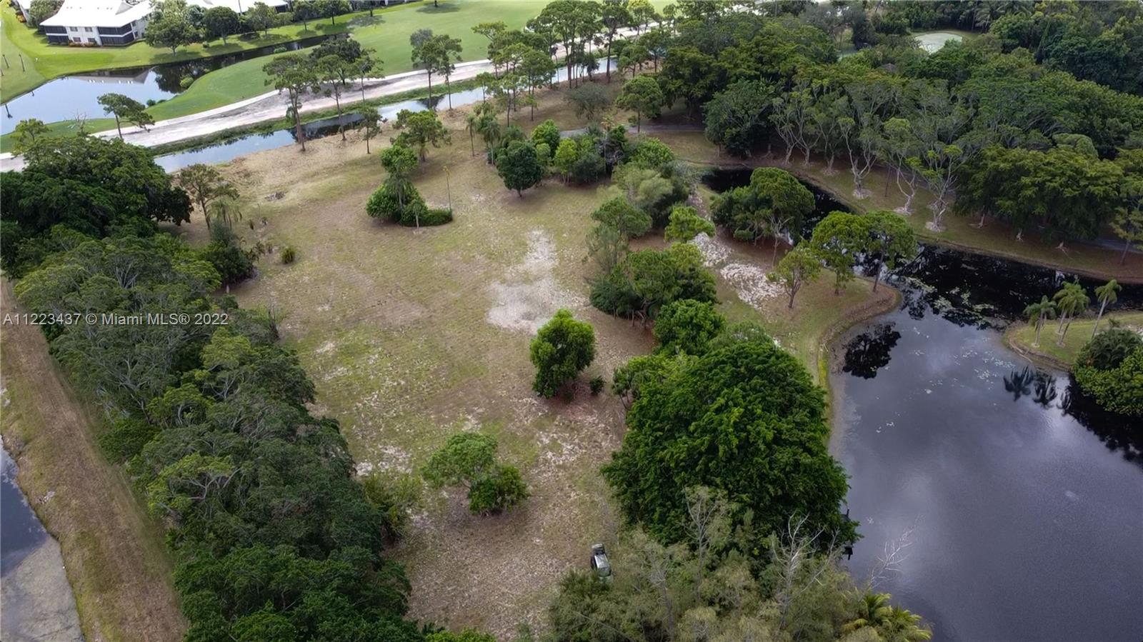 6017 Le Lac Road Boca Raton, FL 33496 - Photo 29 of 46 an aerial view of residential house with outdoor space and trees all around