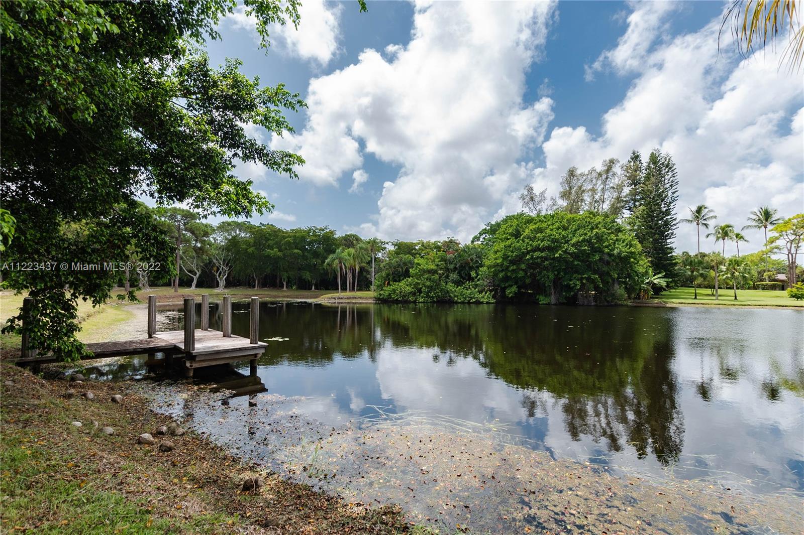 6017 Le Lac Road Boca Raton, FL 33496 - Photo 32 of 46 a view of a lake with a house in the background
