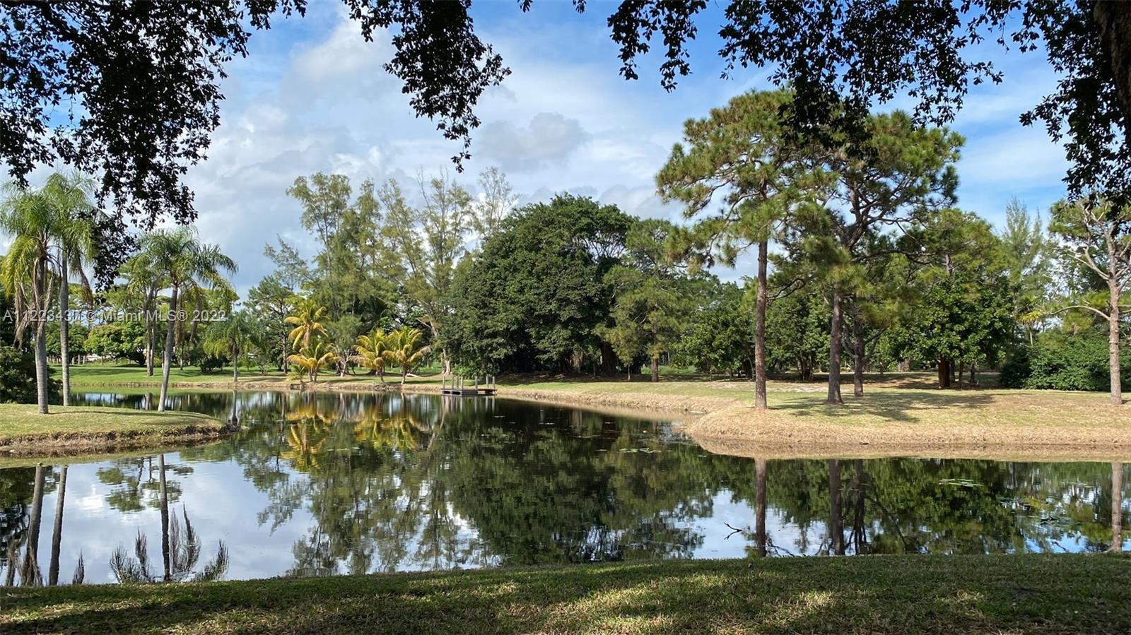 6017 Le Lac Road Boca Raton, FL 33496 - Photo 4 of 46 a view of a lake with a yard