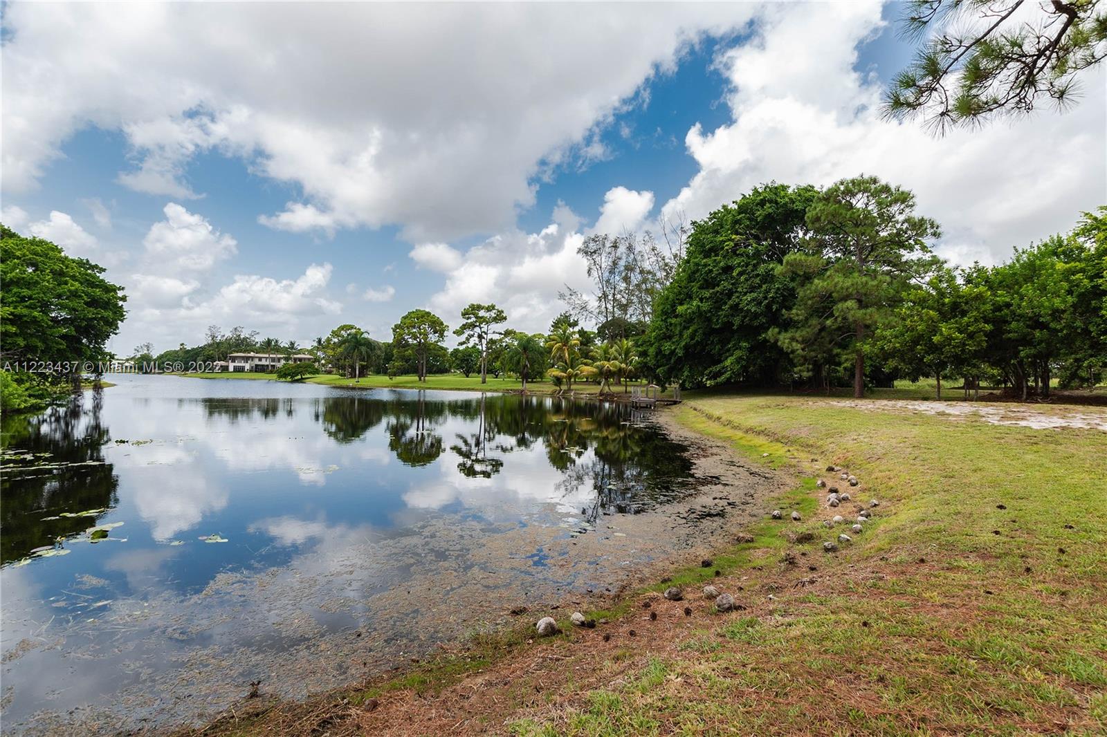 6017 Le Lac Road Boca Raton, FL 33496 - Photo 43 of 46 a view of a lake with houses in the back