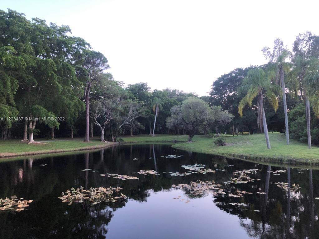6017 Le Lac Road Boca Raton, FL 33496 - Photo 5 of 46 a view of a garden with a lake