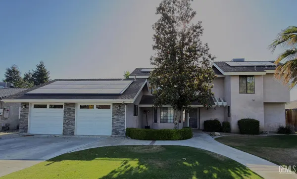 a front view of a house with a yard garage and outdoor seating