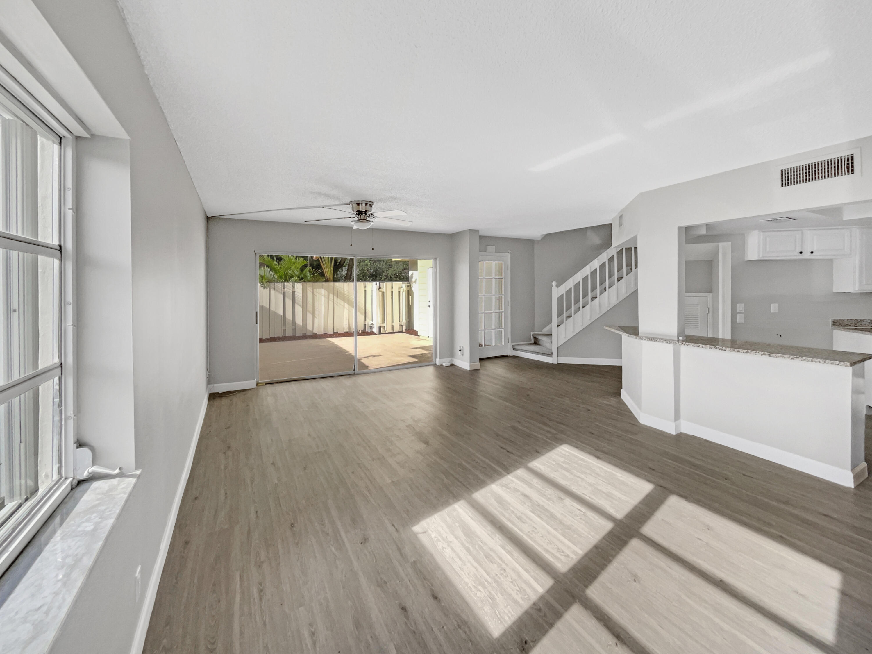 109 Seabreeze Circle Jupiter, FL 33477 - Photo 11 of 28 a view of an empty room with wooden floor and a window