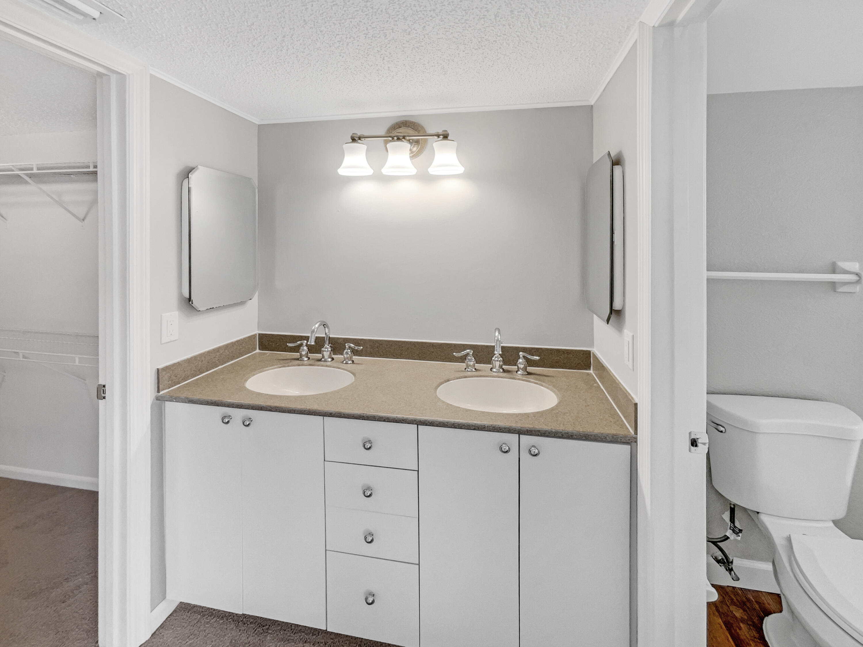 109 Seabreeze Circle Jupiter, FL 33477 - Photo 15 of 28 a bathroom with a granite countertop sink toilet and mirror