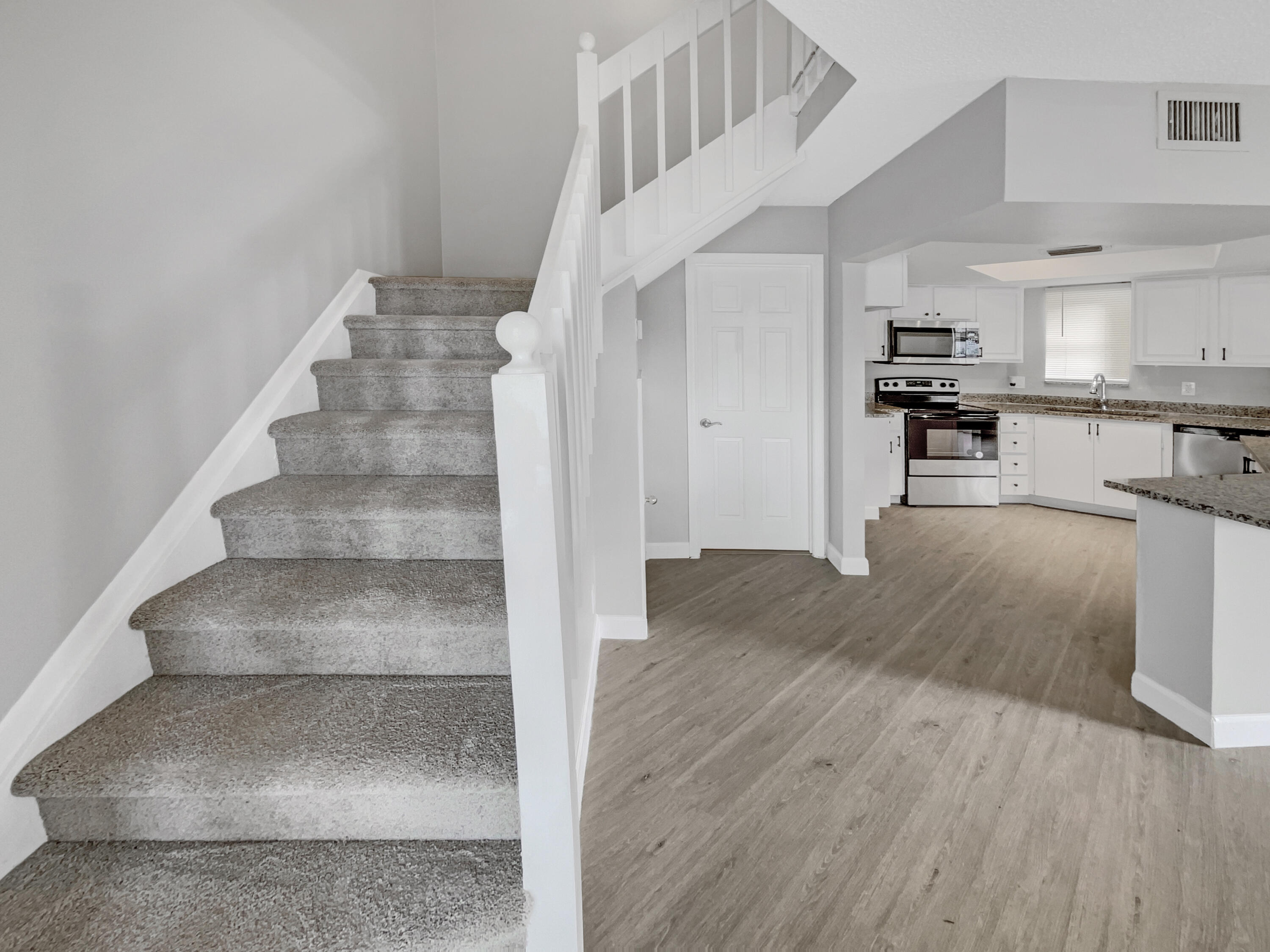109 Seabreeze Circle Jupiter, FL 33477 - Photo 22 of 28 a view of kitchen and hall with wooden floor