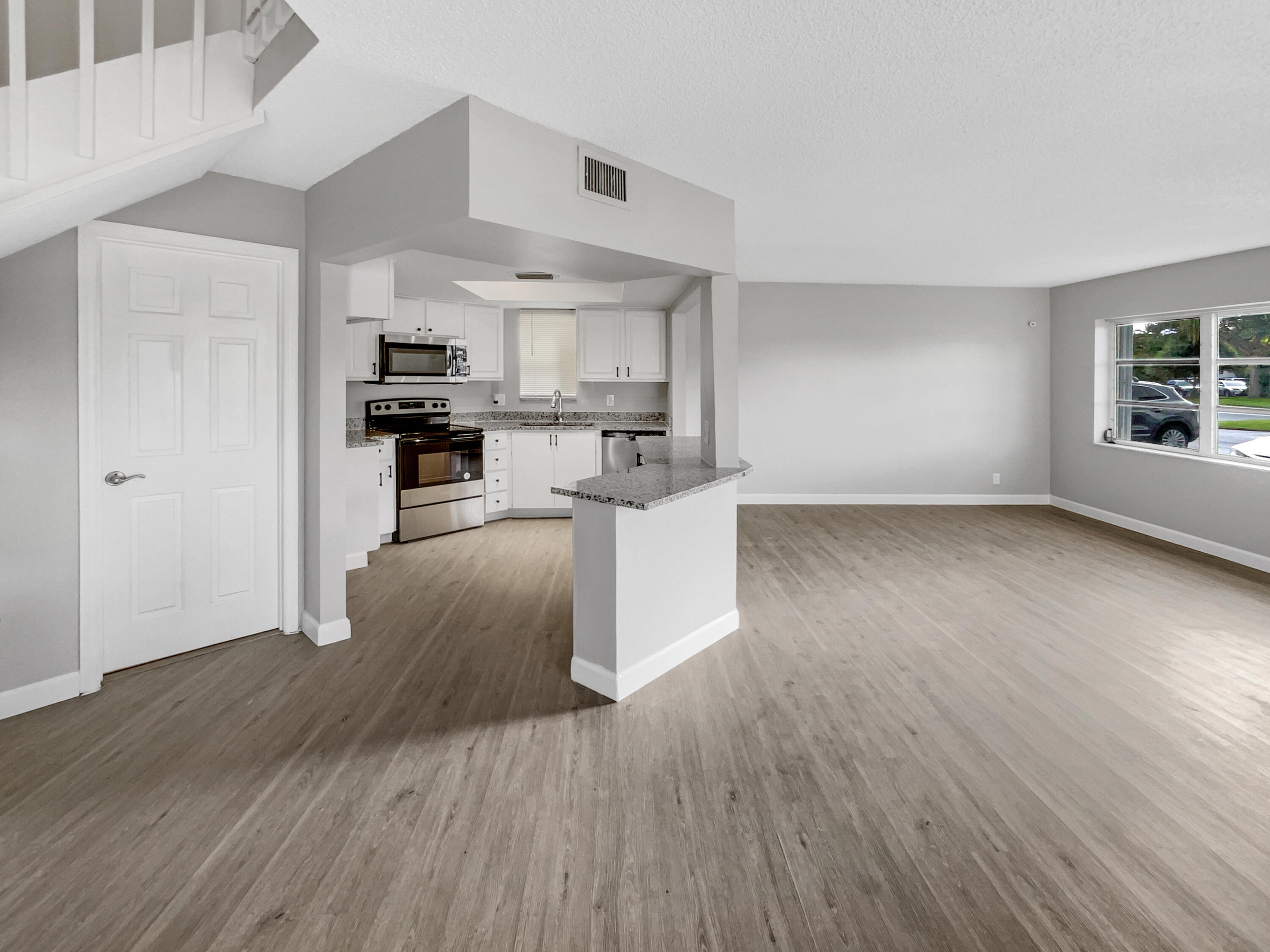 109 Seabreeze Circle Jupiter, FL 33477 - Photo 23 of 28 a view of a kitchen with microwave and cabinets