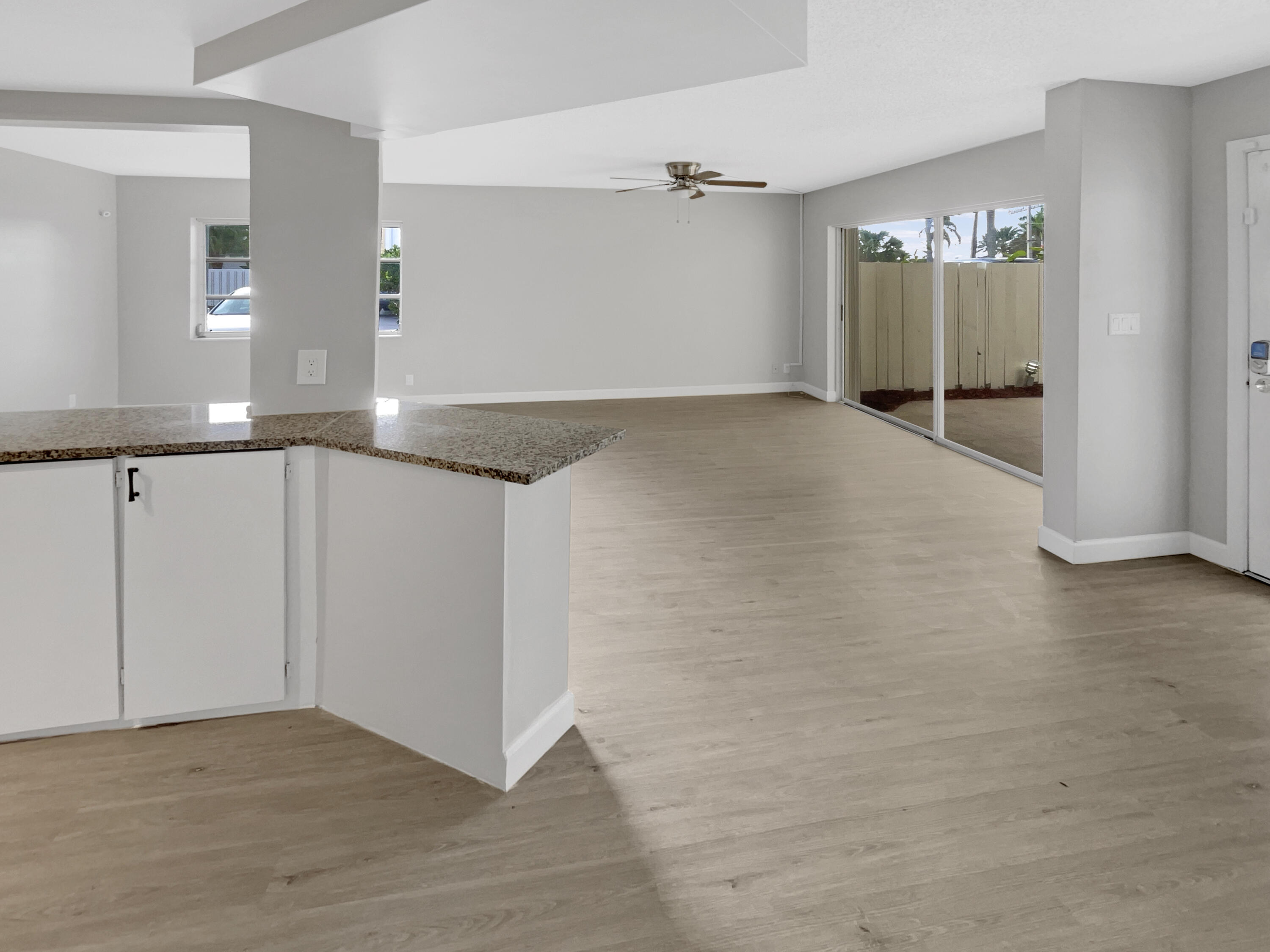 109 Seabreeze Circle Jupiter, FL 33477 - Photo 24 of 28 a view of an empty room with window and wooden floor