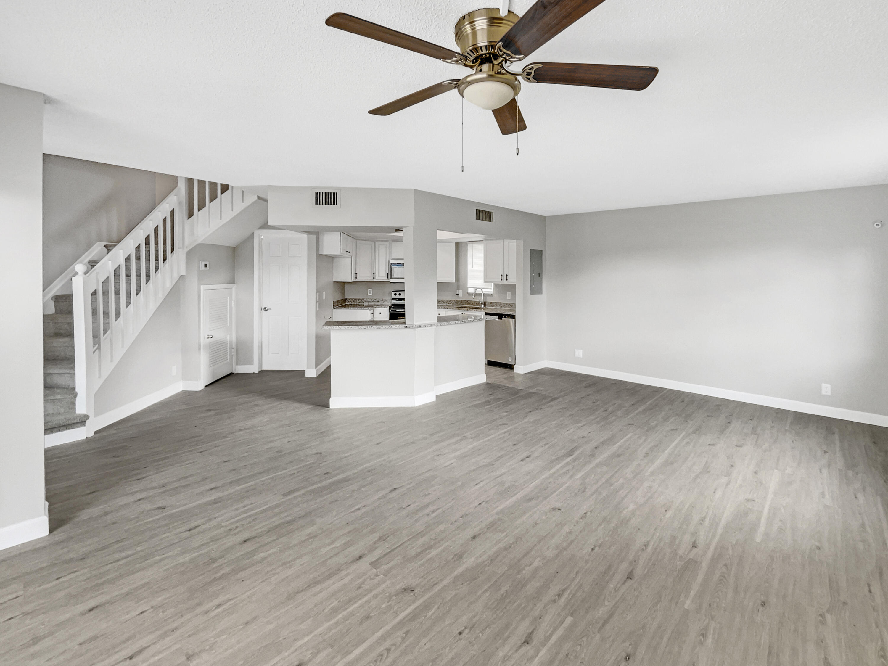 109 Seabreeze Circle Jupiter, FL 33477 - Photo 5 of 28 a view of a kitchen with wooden floor a sink and a window