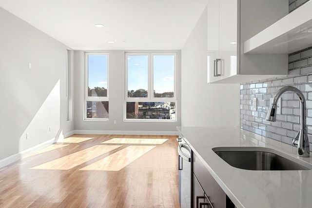 a kitchen with a sink and a large window