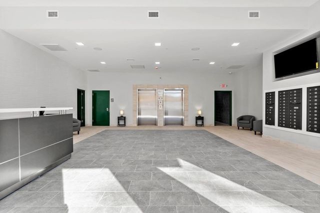 a large bedroom with a large bed and a flat screen tv