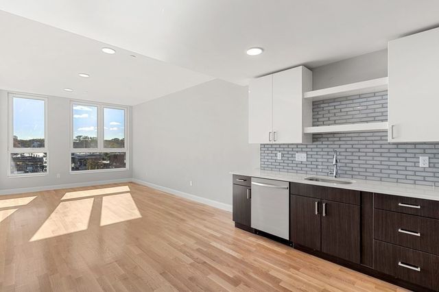 a view of a kitchen with a sink and a window