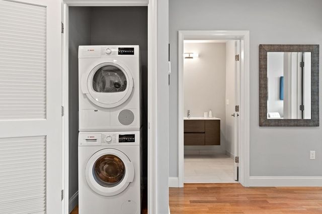 a view of a hallway with washer and dryer