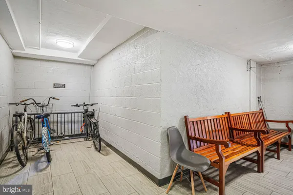 a view of a room with chairs and wooden floor