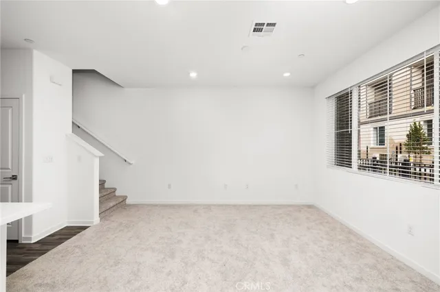 a kitchen with a sink stainless steel appliances and white cabinets