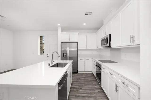 a kitchen with a sink and a refrigerator