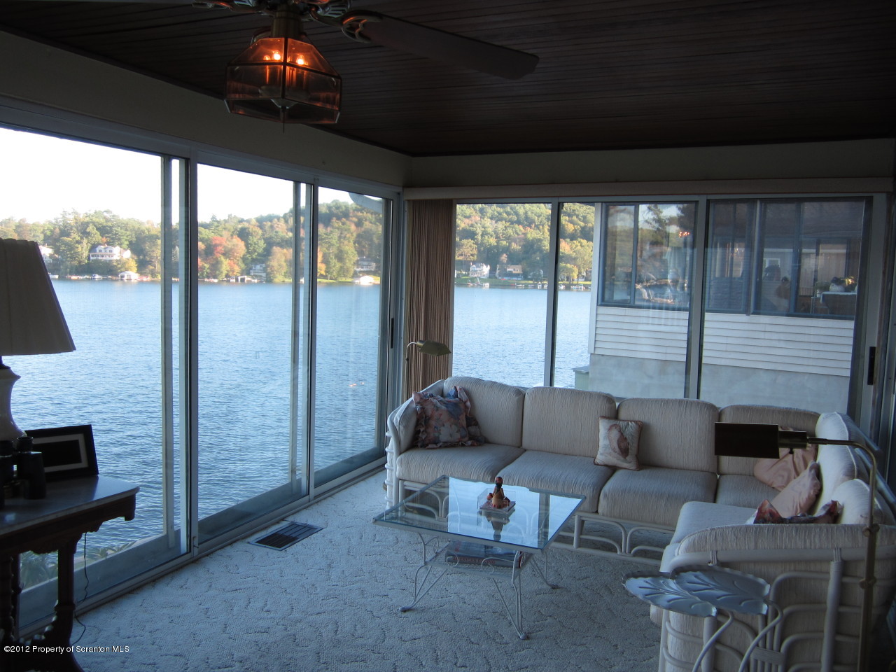 362 Point Road Lake Winola, PA 18419 - Photo 37 of 42 a living room with furniture and a floor to ceiling window