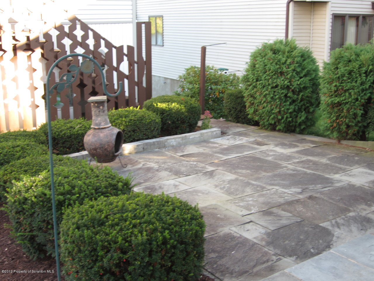 362 Point Road Lake Winola, PA 18419 - Photo 6 of 42 a view of a garden with potted plants and brick walls