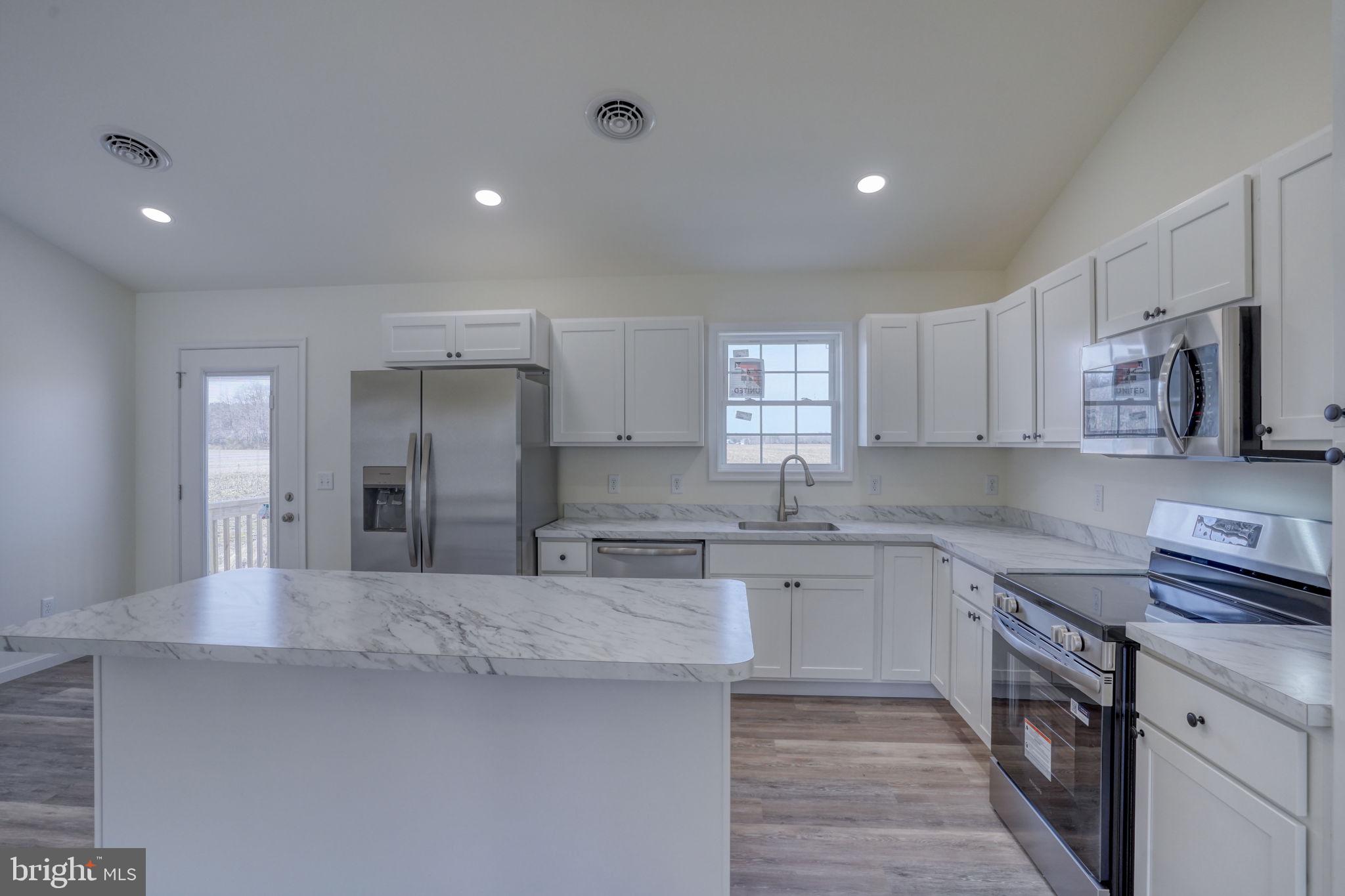 11064 North Union Church Road Lincoln, DE 19960 - Photo 18 of 35 a kitchen with stainless steel appliances granite countertop a sink stove and refrigerator