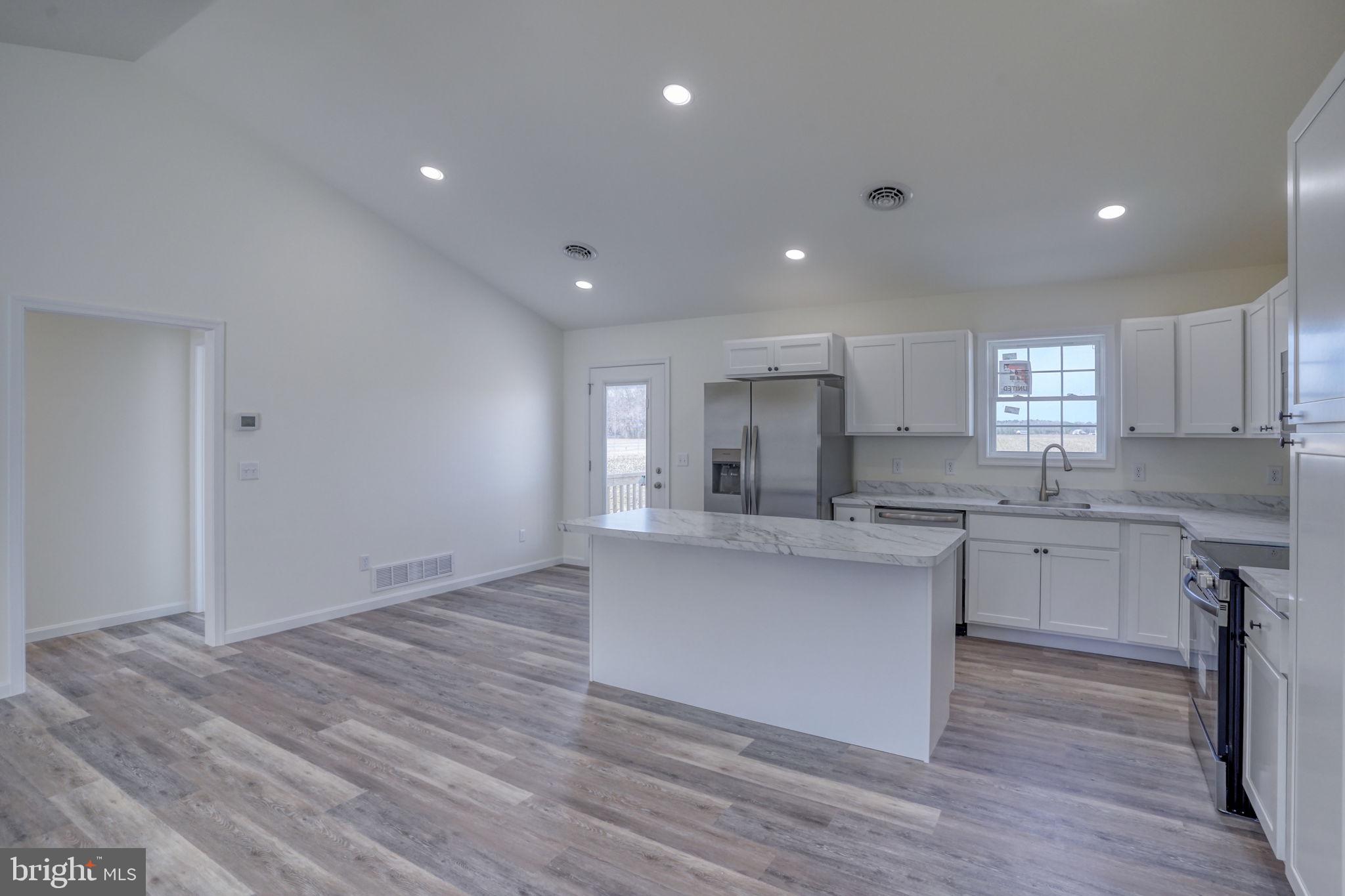 11064 North Union Church Road Lincoln, DE 19960 - Photo 19 of 35 a kitchen with stainless steel appliances granite countertop a sink cabinets and wooden floor