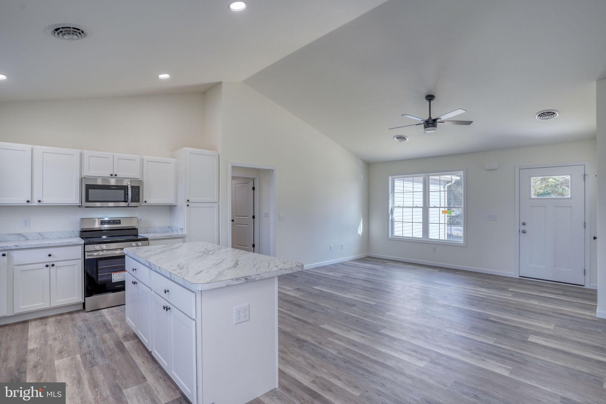 11064 North Union Church Road Lincoln, DE 19960 - Photo 21 of 35 a kitchen with stainless steel appliances granite countertop a sink stove and refrigerator