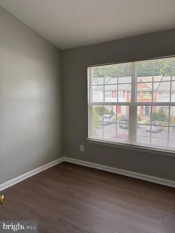 a view of a livingroom with wooden floor and closet