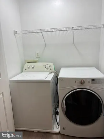 a view of an empty room with closet and a window